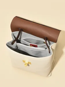 Stylish women's backpack with contrasting brown flap and gold hardware for daily use.