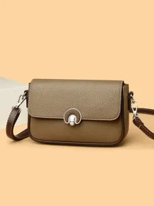 Stylish women's brown leather crossbody shoulder bag with metal lock for daily use and commute.
