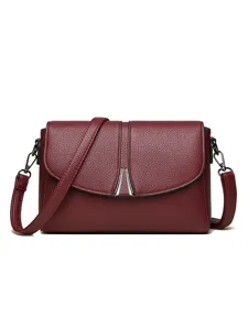 Elegant wine red leather crossbody bag for women, stylish shoulder purse with metal accent.