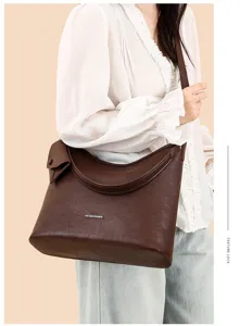 Close-up of stylish brown leather hobo shoulder bag, large capacity, premium commuter.