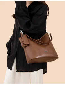 Minimalist brown leather shoulder bag for women, large capacity commuter tote with small pouch.
