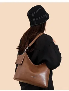 Brown leather hobo shoulder bag with small pouch detail, large capacity casual commuting tote.