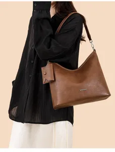 Brown leather shoulder bag detail, large capacity hobo tote with small pouch and metal hardware.