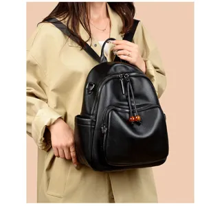 Detailed view of the black soft leather backpack, showing durable straps and zipper pockets.