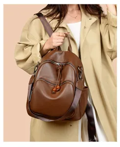 Brown soft leather women backpack detail, multi-pocket design, anti-theft shoulder bag.