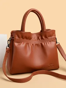 Brown leather drawstring tote handbag shoulder bag with dual top handles and strap.