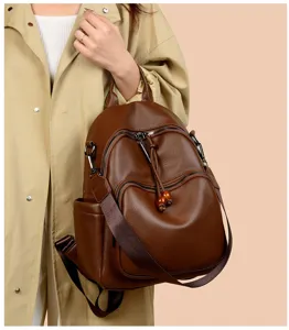 Detailed view of the stylish brown soft leather women backpack showing texture and strap design.