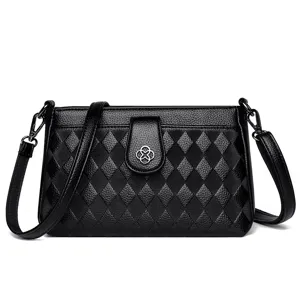Stylish black quilted leather crossbody bag for women, featuring a chic flower clasp.