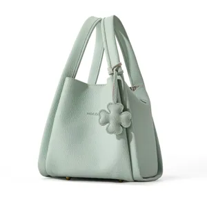 Light green leather handbag bucket tote bag with double top handles and clover charm.