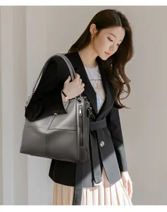 Grey leather tote bag for women, stylish shoulder handbag with zipper design and spacious interior.