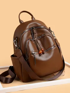 Stylish brown soft leather backpack for women with multiple zippers and adjustable straps.