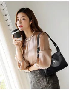 Elegant black shoulder bag for women, featuring casual design, adjustable wide strap and spacious capacity.