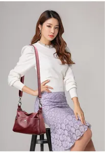 Casual women leather shoulder crossbody bag with wide strap and large daily commuter capacity.