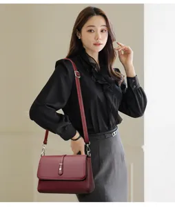 Elegant wine red leather crossbody bag with metal clasp for women daily commuting style.