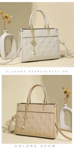 Detail view of stylish quilted leather tote handbag, featuring elegant gold hardware details.