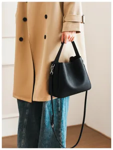 Black soft leather bucket bag detail view, stylish shoulder strap and metal hardware design.