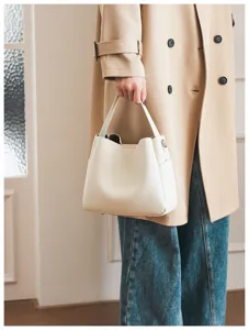 Detail shot of the elegant white soft leather bucket bag showing fine texture and daily style.