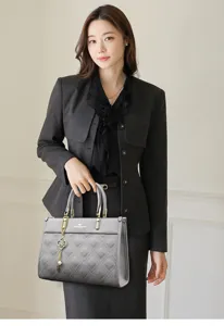 Elegant women's leather quilted tote bag with chain charm, professional fashion handbag for work.