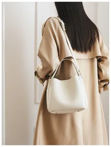 Detailed view of women's soft leather bucket bag, elegant shoulder and crossbody design.