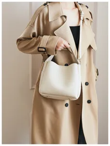 Detailed shot of a stylish white soft leather bucket bag, showing versatile crossbody design.