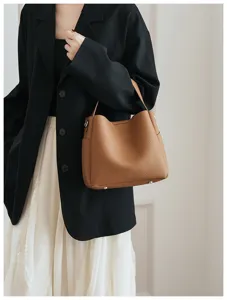 Soft leather bucket bag detail view, versatile design with elegant brown finish and hardware.