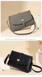 Detail view of the stylish leather cross-body bag with elegant golden clasp and strap.