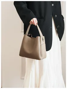 Close-up detail of soft leather bucket bag for women, showing premium texture and handle.