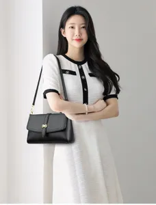 Elegant women's black leather shoulder bag with chic metal clasp, ideal for daily urban style.