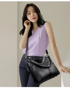 Detail view of stylish black leather shoulder bag for women, elegant daily tote and purse.