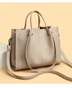 Minimalist soft leather tote bag detail, featuring durable handles and wide shoulder strap.