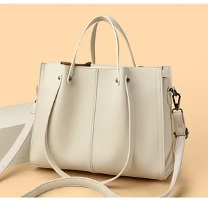 Detailed view of women's minimalist soft leather tote bag with wide strap for business commute.