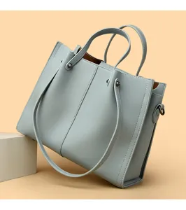 Elegant light blue leather tote bag for women, business commuting handbag with dual handles.