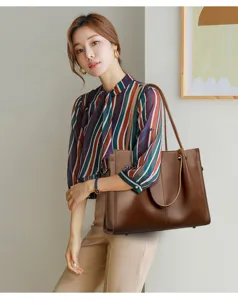 Minimalist soft leather tote bag for women, featuring a spacious interior and comfortable straps.