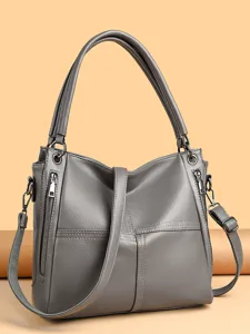 Elegant grey leather shoulder bag for women, stylish tote handbag with spacious compartments.