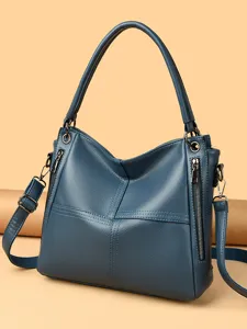 Blue leather women shoulder bag casual tote handbag with zipper pockets and top handles.