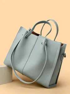 Minimalist soft leather tote bag for women, large capacity commuter shoulder handbag for daily work.