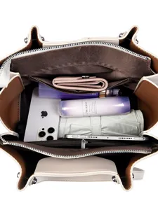 Spacious soft leather tote bag for women, featuring multi-compartment interior capacity for daily commute.