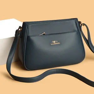Stylish dark blue leather shoulder bag for women, versatile soft crossbody bag with zipper pocket.