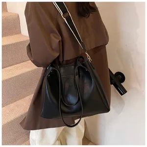 Stylish women's black leather tote bag with wide shoulder strap and spacious capacity.