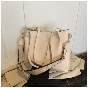 Detailed view of the beige bucket bag showcasing the wide contrast shoulder strap and PU leather.