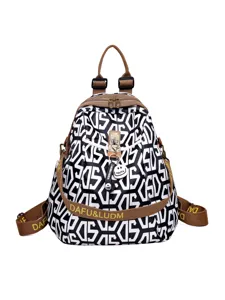 Fashionable black and white geometric women's backpack with brown straps and metal lock main view