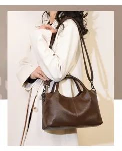 Retro brown leather commuter handbag, minimalist spliced design with adjustable shoulder strap.