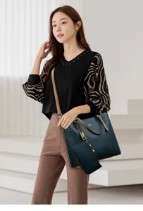 Detailed showcase of the dark green leather tote bag featuring a wide strap and matching pouch.