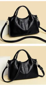 Close-up detail of the black PU leather handbag showing fine texture and adjustable strap.