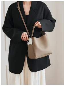 Detail view of the soft leather bucket bag with a convenient side pocket and elegant strap.