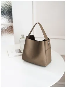 Detailed view of the taupe soft leather bucket bag showing fine texture and craftsmanship.
