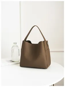 Detailed shot of brown soft leather bucket bag interior and texture in minimalist setting.