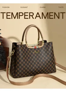 Detailed view of the stylish monogram handbag featuring metallic handles and adjustable strap.