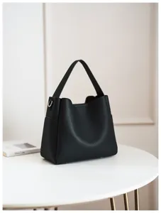 Detailed view of the soft leather bucket bag showing its fine texture, handle, and stitching.