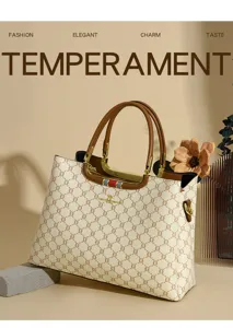 Elegant women's handbag detail showcasing premium printed leather and chic golden hardware.